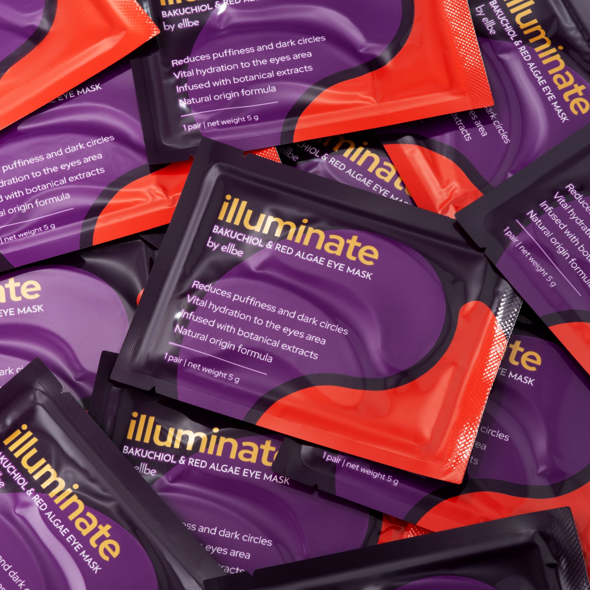 Multiple packets of Illuminate eye mask with purple and orange design.